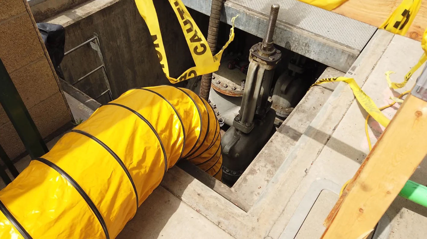 Flexible ventilation duct supplying fresh air into a confined space for worker safety